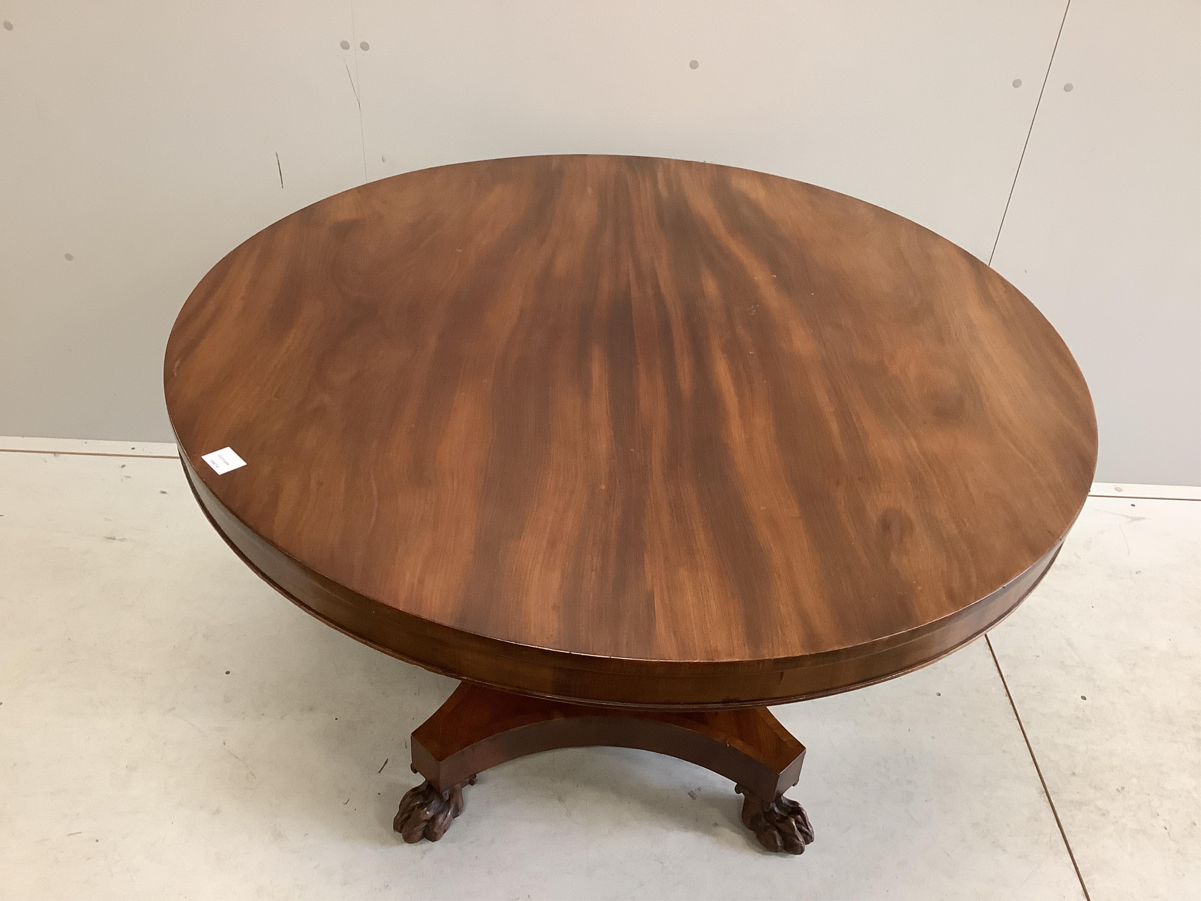 An early Victorian mahogany circular tilt top breakfast table, on a pillar and flat quadruple platform base, diameter 120cm, height 74cm. Condition - good